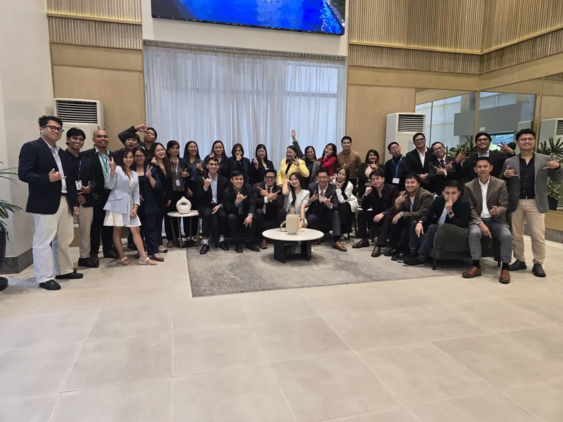 Team Elite members laughing together after a group photo at the DMCI Homes showroom